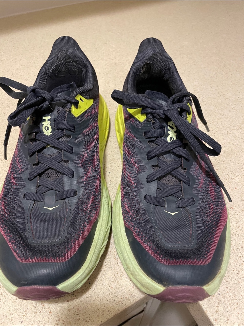 Hoka Black, purple, yellow  Running Shoes. One insole missing.